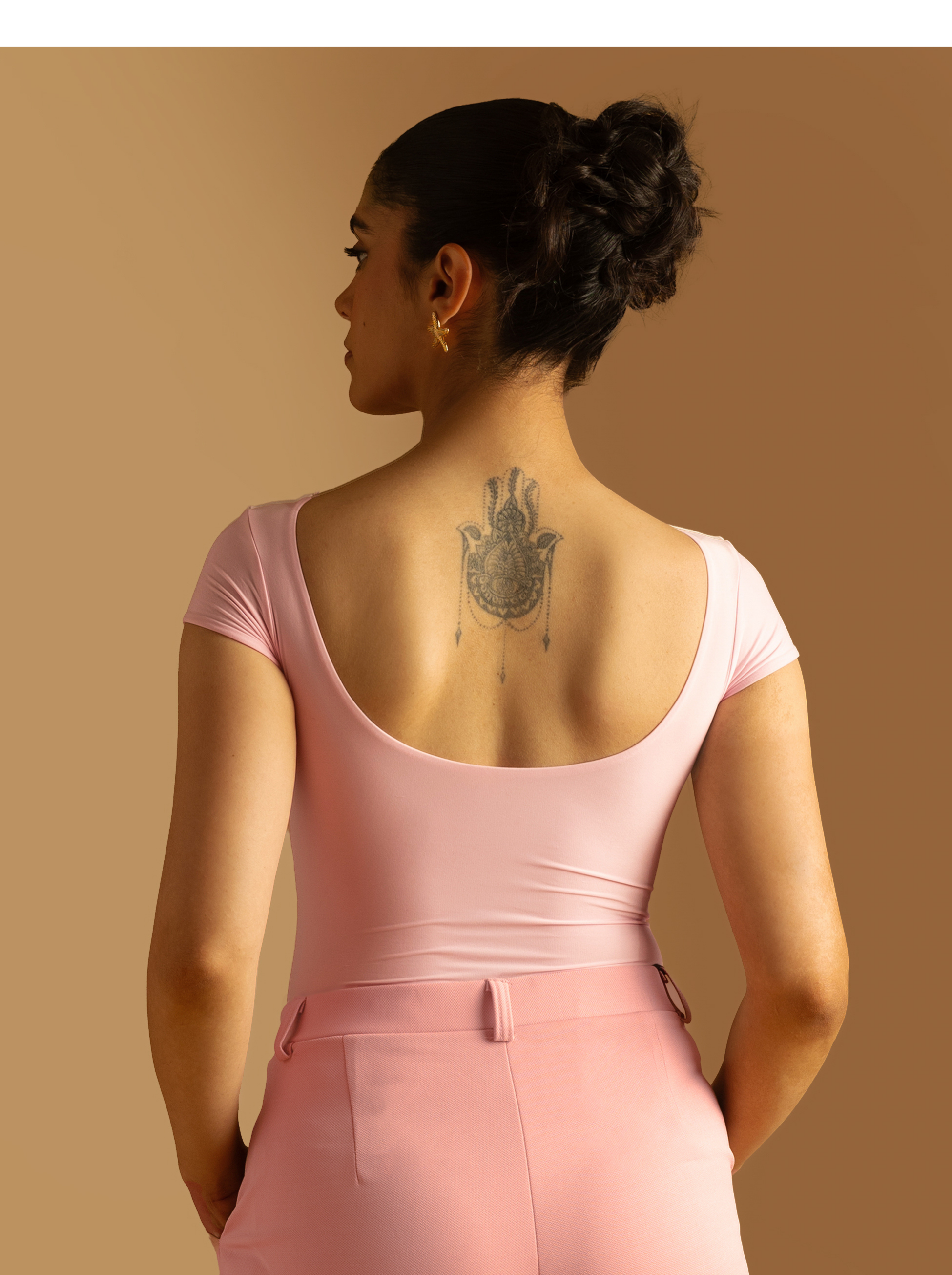 ButterBawd Boat Neck Bodysuit in pink, displayed on a hanger, smooth fabric